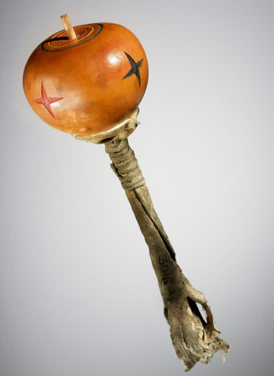 Skidi Pawnee rattle, ca. 1890; Oklahoma; Gourd, wood, hide, pigment; 27 x 10 cm