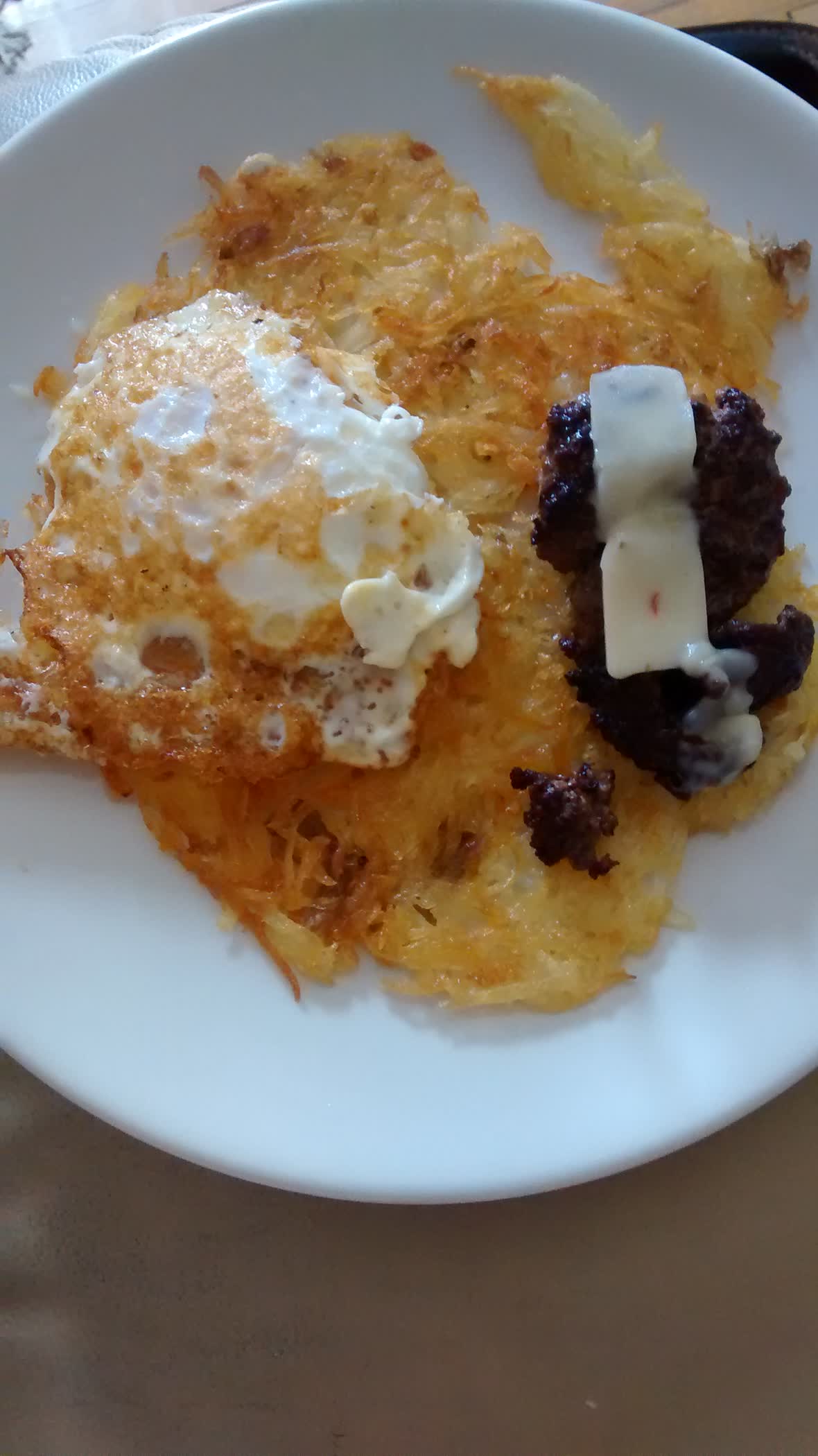  Rosti, fried egg, cheese, and chorizo.